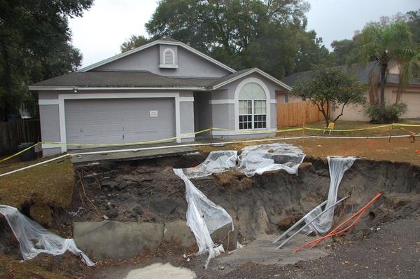 Sinkhole in front of house. Photo from USGS